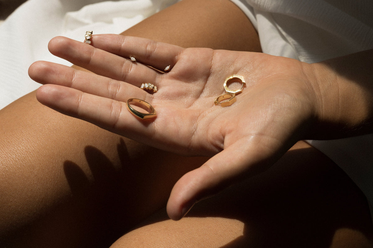 Karat kilat carat fine jewelry guide showcasing elegant rings on a hand.