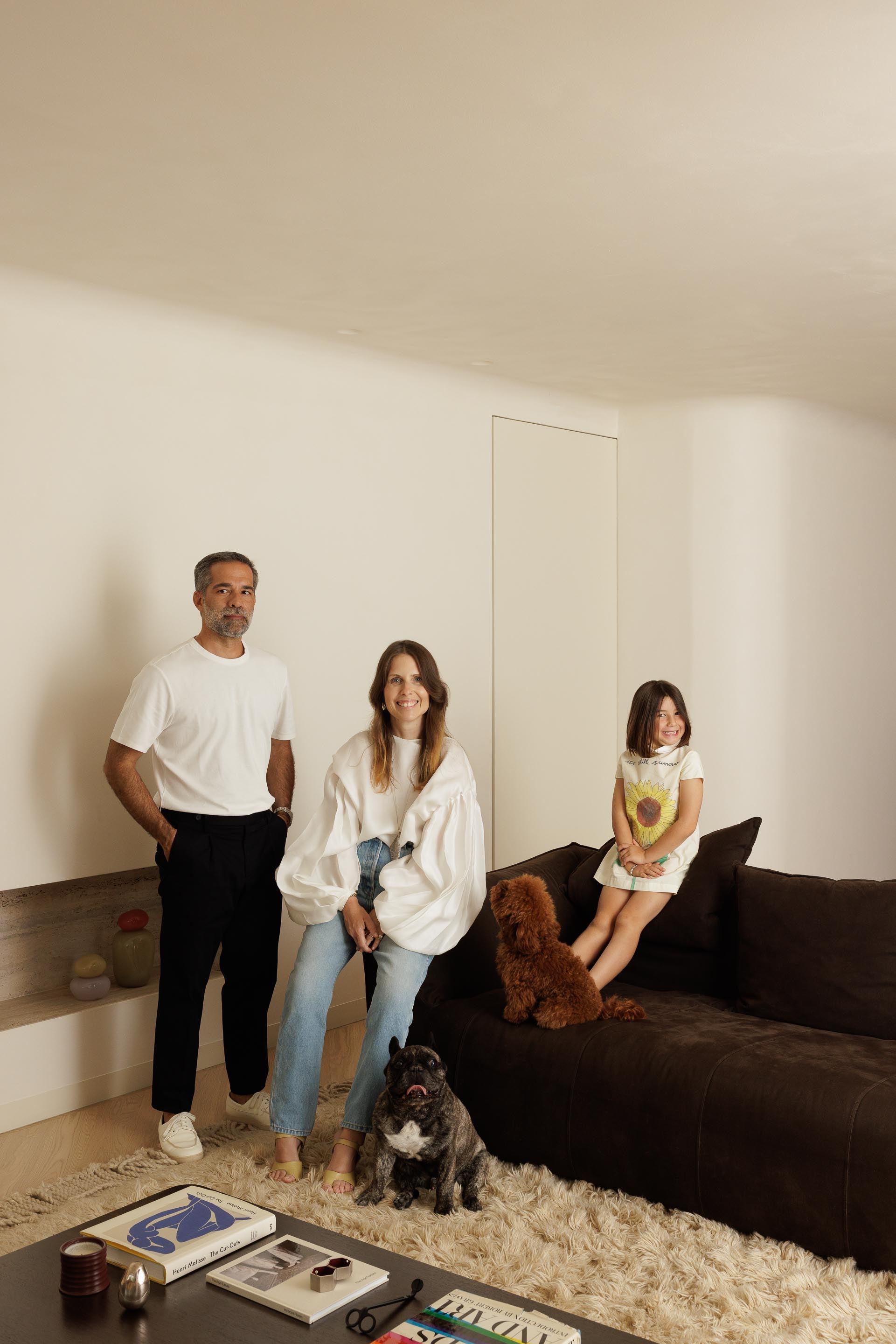 Family of four with a dog in a modern living room