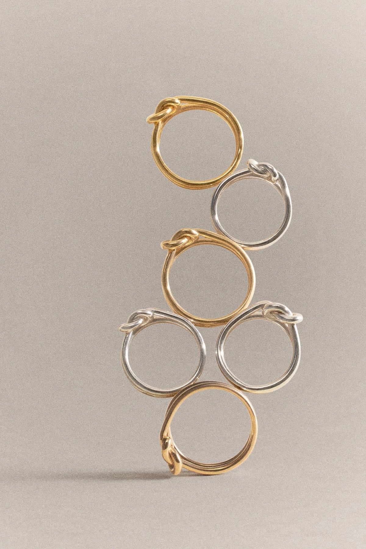 A stack of rings, showcasing both gold and silver styles, exemplifying reviving sterling silver jewelry.