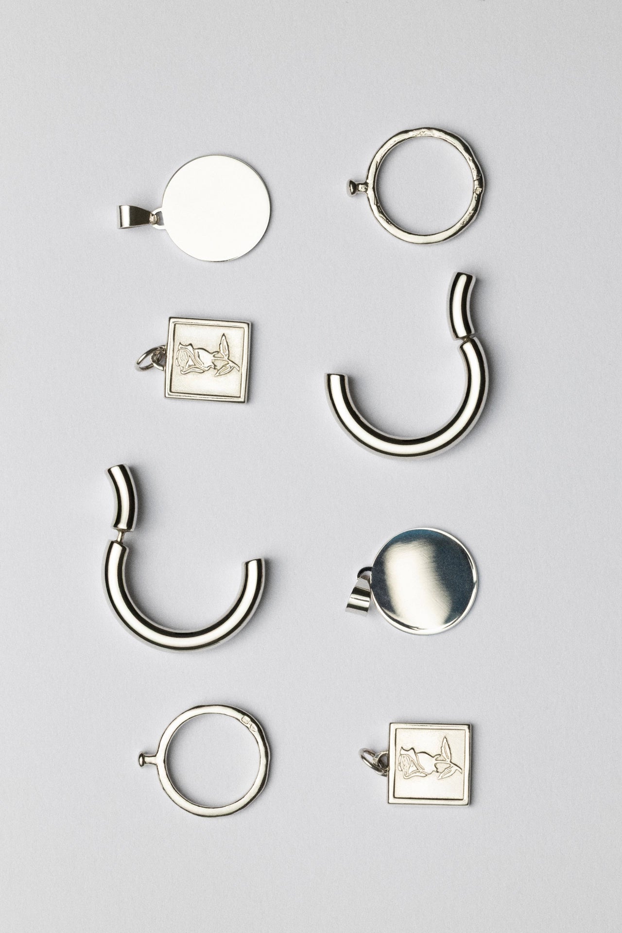 Collection of silver jewelry pieces on a light gray background Exclusive CINCO jewelry archive - curated selection of limited designs