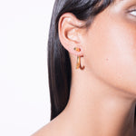 model wearing cat earrings in gold