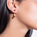 model wearing cat earrings in gold