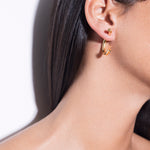 model wearing cat earrings in gold