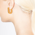 model wearing fiona earrings in gold