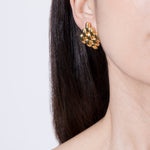 model wearing gala earrings in gold 