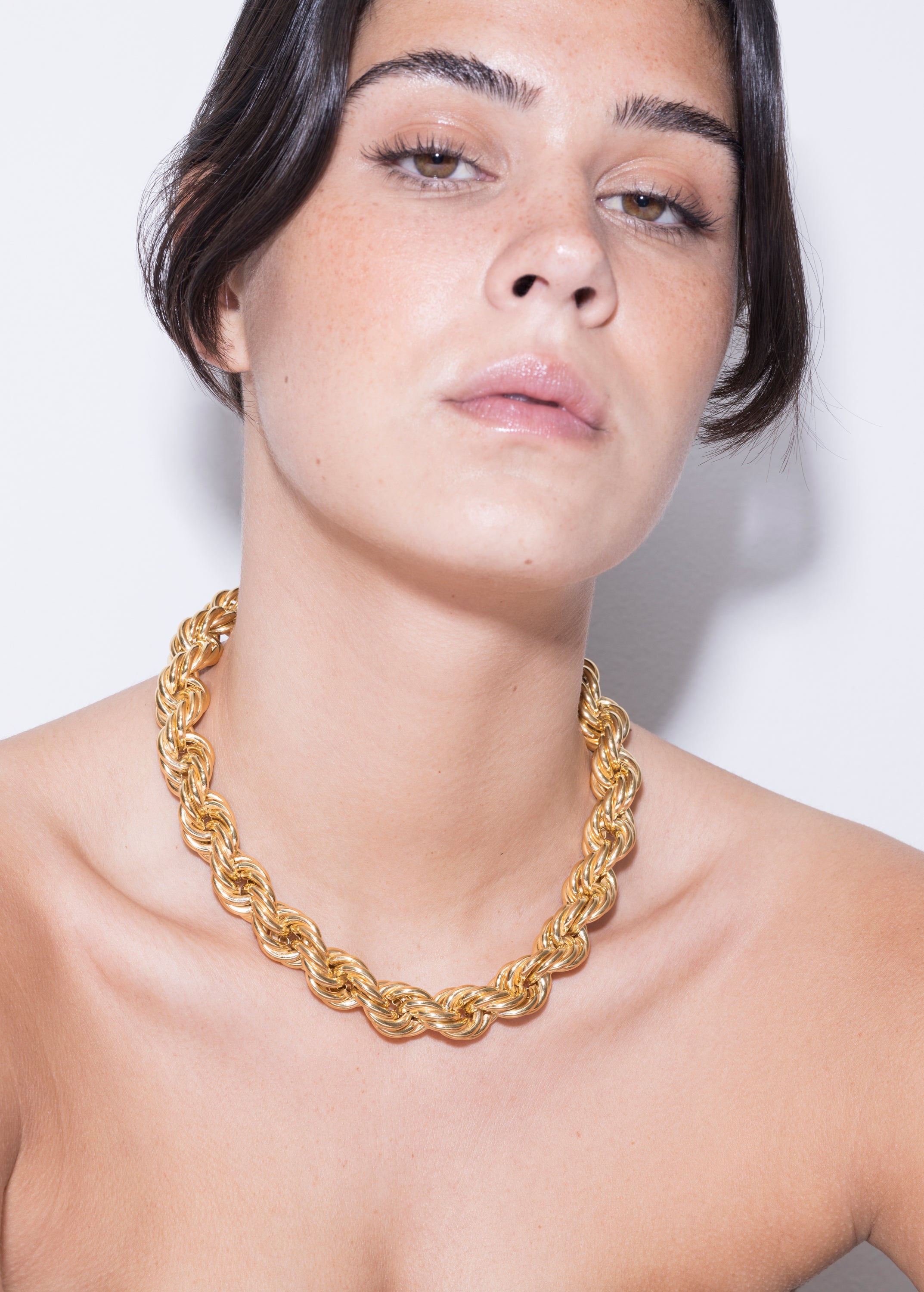 model wearing goliath bia necklace in gold