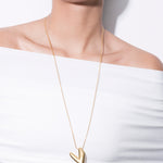 model wearing kokoro necklace in gold