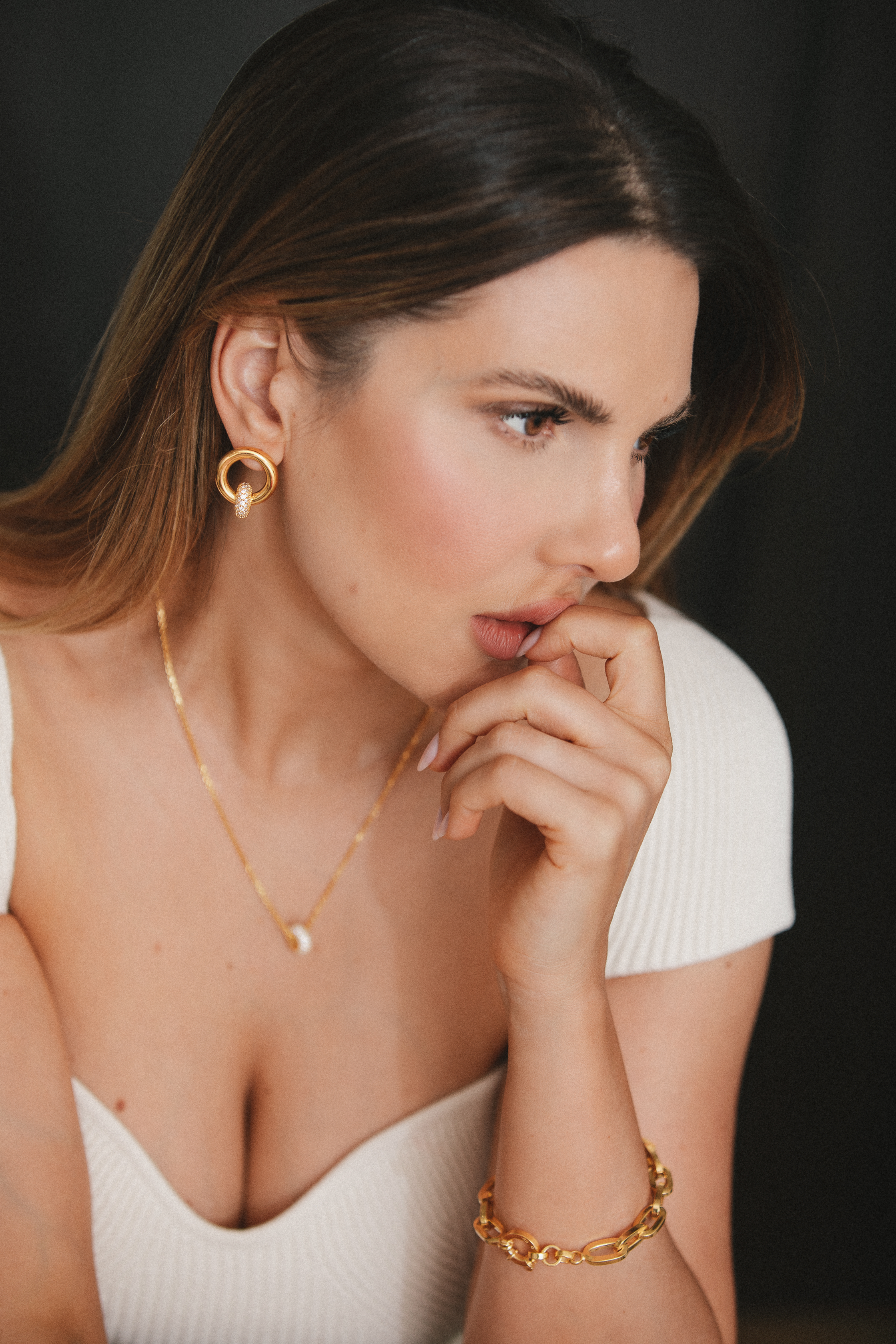 model wearing nina earrings, nina necklace and eden bracelet in gold