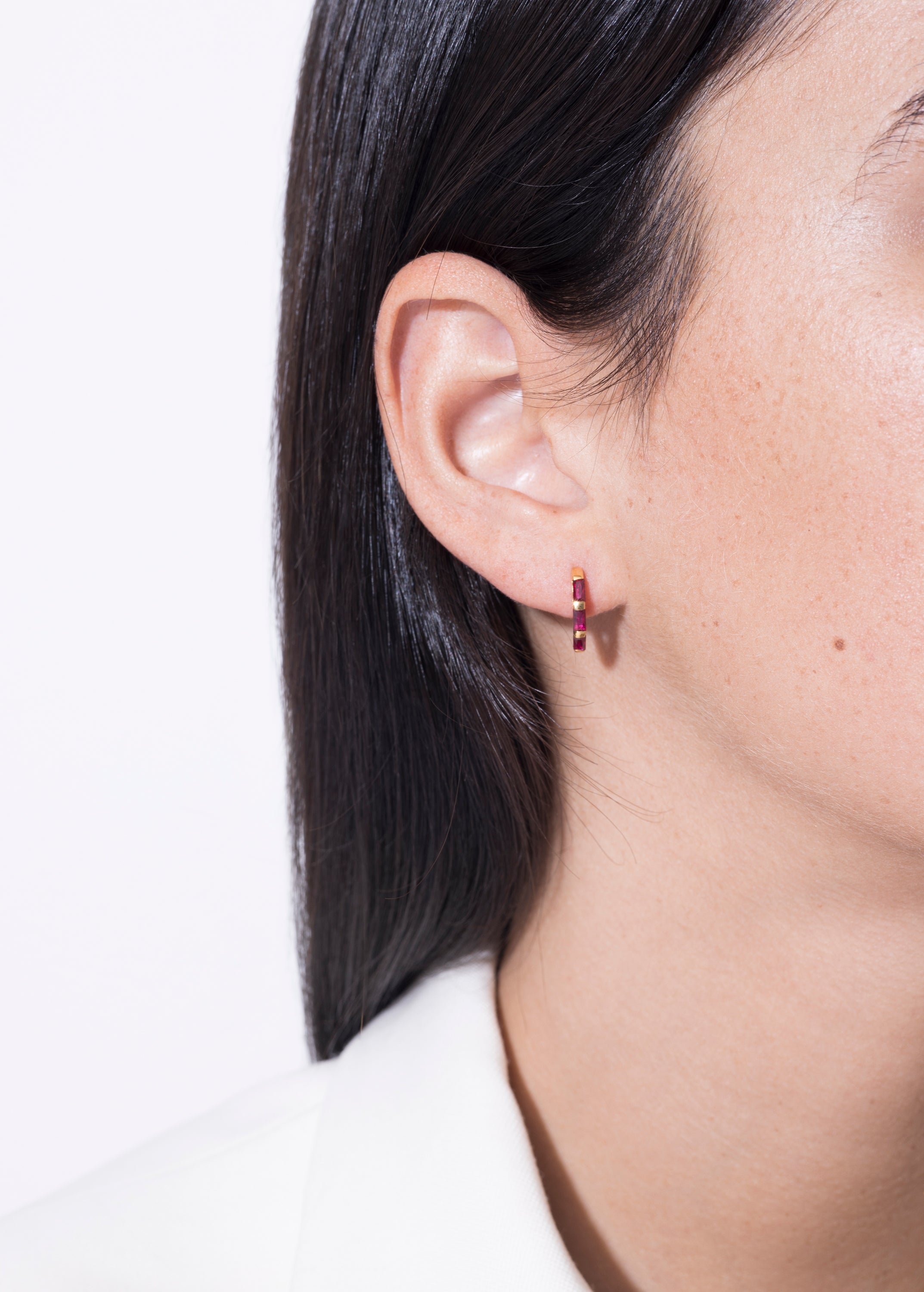 model wearing norma earrings rubi in gold