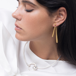 model wearing mini sade earrings and sade earrings in gold and éli choker in silver