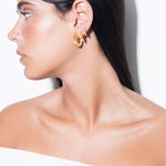 model wearing sara earrings, sara huggies and sara mini earrings in gold