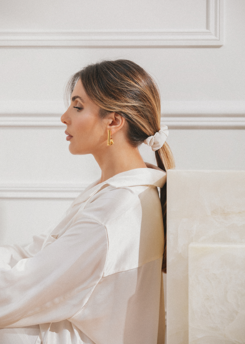 model wearing tina earrings in gold