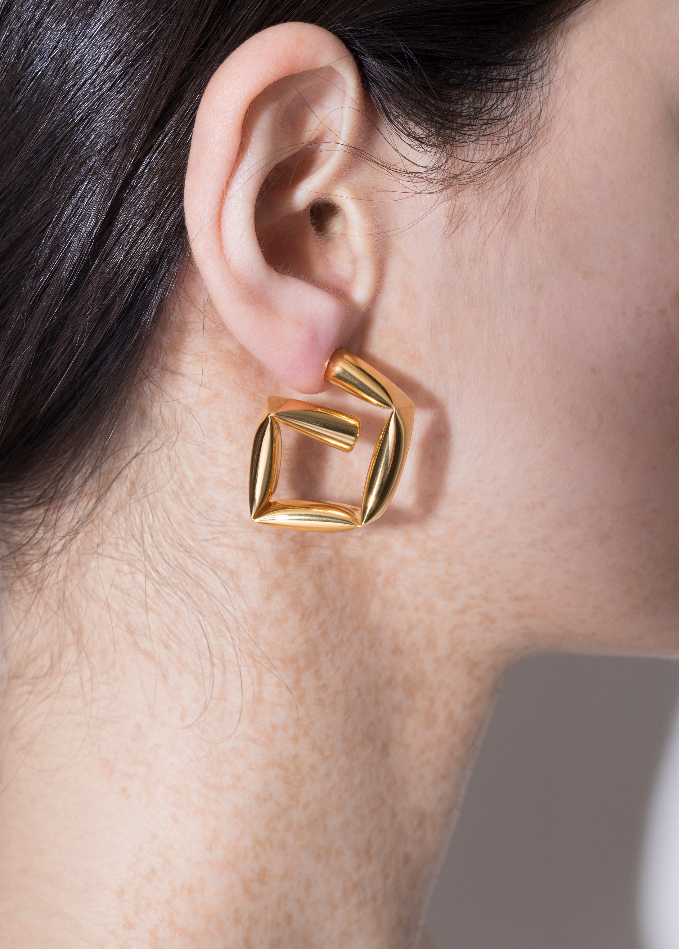 model wearing tina wrapped earrings in gold